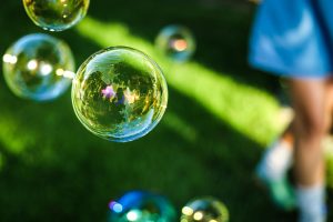 A picture of bubbles in and out of focus in what appears to be a backyard.