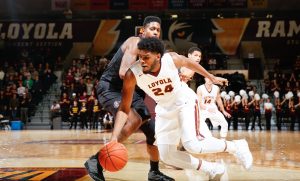 Loyola player dribbling a basketball while driving into the paint