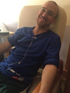 Christian Heimall in a chair receiving cancer treatment
