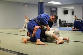 Martial arts instructor sparring with student 