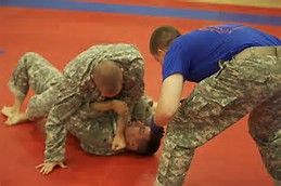 two soldiers conduct martial arts Combatives training