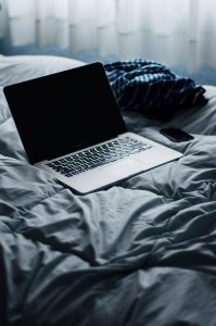 A laptop sitting on a bed