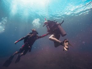 two people SCUBA diving